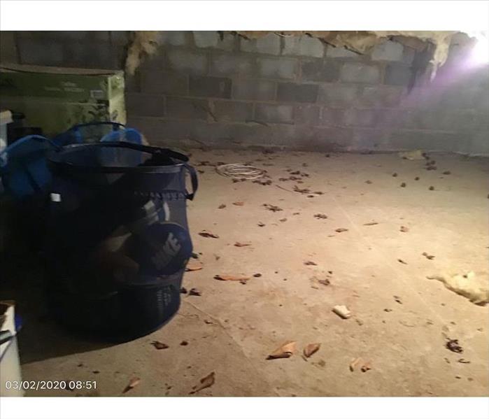 Basement with debris on a concrete floor