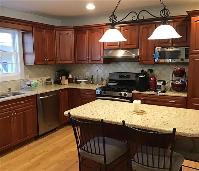 Clean kitchen with appliances and island eating nook