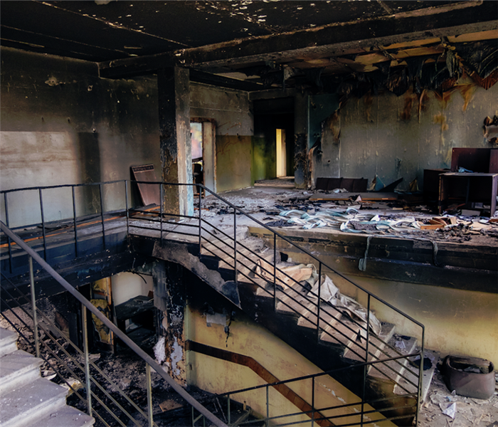 a fire damaged room with soot covering everything